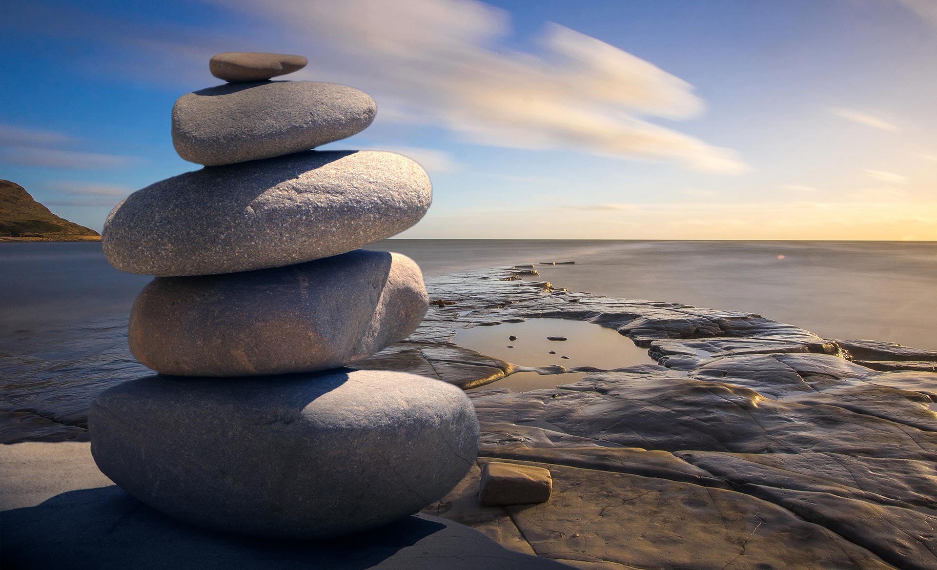Stacked stones representing reflection and self-compassion